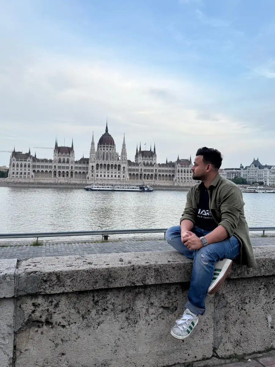 Fatik Rahman by the Danube with the Hungarian Parliament, Budapest